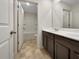 The bathroom boasts double sinks, tiled floor, and a built-in bathtub-shower combination at 1477 Harlequin Way, Stockbridge, GA 30281