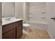 This bathroom has a tiled floor, a built-in bathtub-shower combination and a brown vanity at 1477 Harlequin Way, Stockbridge, GA 30281