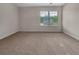 Empty bedroom with carpet and window view, ready for customization at 1477 Harlequin Way, Stockbridge, GA 30281