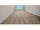 Carpeted bedroom with window for natural light at 1477 Harlequin Way, Stockbridge, GA 30281