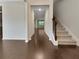 Inviting entryway with hardwood floors and staircase, leading to an open-concept living space flooded with natural light at 1477 Harlequin Way, Stockbridge, GA 30281