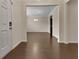 Bright entryway with hardwood floors, showcasing an open view to the dining room and elegant chandelier at 1477 Harlequin Way, Stockbridge, GA 30281
