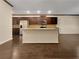Modern kitchen featuring an island, stainless steel appliances, granite countertops, and dark wood cabinetry at 1477 Harlequin Way, Stockbridge, GA 30281