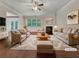 Bright living room featuring neutral tones, a fireplace, and hardwood floors, virtually staged for comfort and style at 1477 Harlequin Way, Stockbridge, GA 30281