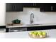 Modern kitchen featuring black cabinets, stainless steel appliances, white countertops, and subway tile backsplash at 1604 Driggs Nw Dr # 160, Atlanta, GA 30318