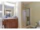 Bathroom with a large mirror, granite countertop, and glass shower door at 2703 Brookhavenrun Cir, Duluth, GA 30097