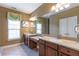 Bathroom features double sinks, tile flooring, and a large mirror at 2703 Brookhavenrun Cir, Duluth, GA 30097
