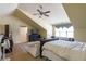 Finished attic bedroom with vaulted ceiling, ceiling fan, and sitting area near the window at 2703 Brookhavenrun Cir, Duluth, GA 30097
