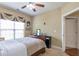 Bedroom with a ceiling fan, window with blinds and curtains, and queen bed with upholstered headboard at 2703 Brookhavenrun Cir, Duluth, GA 30097