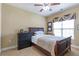 Bedroom with a ceiling fan, window with blinds and curtains, and queen bed with upholstered headboard at 2703 Brookhavenrun Cir, Duluth, GA 30097
