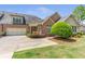 Beautiful home exterior with brick accents, a two-car garage, and lush green landscaping at 2703 Brookhavenrun Cir, Duluth, GA 30097