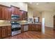 Well-equipped kitchen with stainless steel appliances, granite countertops, and rich wood cabinetry at 2703 Brookhavenrun Cir, Duluth, GA 30097
