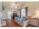 Cozy living room with hardwood floors, fireplace, and large windows with custom draperies at 2703 Brookhavenrun Cir, Duluth, GA 30097