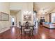 Spacious living area featuring gleaming hardwood floors, a dining table, and an open-concept design at 2703 Brookhavenrun Cir, Duluth, GA 30097