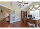 Inviting office featuring hardwood floors, vaulted ceiling, a large desk and easy access to other rooms at 2703 Brookhavenrun Cir, Duluth, GA 30097