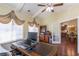 Bright office space features a large desk, wood floors, and decorative window treatments at 2703 Brookhavenrun Cir, Duluth, GA 30097