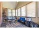 Sunroom featuring light-filled windows, a dining set, and brick accents at 2703 Brookhavenrun Cir, Duluth, GA 30097
