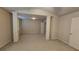 A spacious bonus room with neutral walls, carpet and columns adding architectural detail at 3456 Sardis Bend Dr, Buford, GA 30519