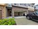 A two-car garage featuring concrete flooring, an automatic door, and stone accents on the townhome's exterior at 3456 Sardis Bend Dr, Buford, GA 30519