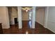 Bright, spacious living room featuring hardwood floors, a cozy fireplace, and elegant decorative columns at 3456 Sardis Bend Dr, Buford, GA 30519