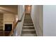 Carpeted staircase with wood railing to upper level at 3456 Sardis Bend Dr, Buford, GA 30519