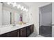 Bathroom with double sinks, white countertops, and dark cabinets at 3670 Casual Ridge Way, Loganville, GA 30052
