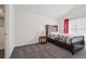 Bedroom features a dark wood frame bed, soft carpet, and neutral wall color at 3670 Casual Ridge Way, Loganville, GA 30052