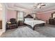 Large bedroom features a trey ceiling, ceiling fan, and neutral carpet at 3670 Casual Ridge Way, Loganville, GA 30052