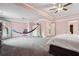 Large bedroom featuring pink walls, neutral carpet, and ceiling fan at 3670 Casual Ridge Way, Loganville, GA 30052