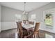 Cozy dining room featuring dark wood floors, wainscoting, and a view of the outdoor patio at 3670 Casual Ridge Way, Loganville, GA 30052