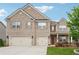 Beautiful brick two-story home with a three-car garage and well-maintained lawn at 3670 Casual Ridge Way, Loganville, GA 30052