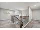 Hallway features carpet, stairs, wooden railings, and white trim at 3670 Casual Ridge Way, Loganville, GA 30052