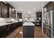 Well-equipped kitchen with dark cabinetry, stainless steel appliances, and a center island at 3670 Casual Ridge Way, Loganville, GA 30052