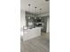 Bright kitchen with gray cabinets, a central island with bar seating, and stainless steel appliances at 4011 Redan Rd # 10, Stone Mountain, GA 30083