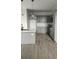 Modern kitchen with an island, quartz countertops, pendant lighting, and gray cabinets at 4011 Redan Rd # 10, Stone Mountain, GA 30083