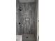 Sleek shower with gray marble-look tiling, a recessed niche, and modern matte black fixtures at 4011 Redan Rd # 10, Stone Mountain, GA 30083