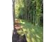 Spacious side yard with lush green grass, bordered by mature trees and a flower bed at 4011 Redan Rd # 10, Stone Mountain, GA 30083