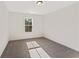 Bright bedroom features neutral carpet, paint, and views of mature trees at 401 Carrera Ln, Acworth, GA 30102