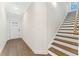 Inviting entryway featuring hardwood floors, a staircase, and front door at 401 Carrera Ln, Acworth, GA 30102