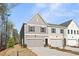Two-story home with gray siding, a two-car garage, and manicured lawn at 401 Carrera Ln, Acworth, GA 30102