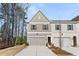 Charming townhome with a modern two-car garage, gray siding, and inviting entrance at 401 Carrera Ln, Acworth, GA 30102