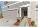 Inviting entrance featuring brick accents, a two-car garage, and manicured landscaping at 401 Carrera Ln, Acworth, GA 30102