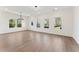 Open-concept living room with hardwood floors, recessed lighting, and large windows at 401 Carrera Ln, Acworth, GA 30102