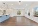 Bright living room featuring hardwood floors, modern lighting, and large windows for natural light at 401 Carrera Ln, Acworth, GA 30102