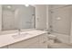 Elegant bathroom with a white vanity, marble countertop, and shower-over-tub with white tiled walls at 525 Parkway Dr # 218, Atlanta, GA 30354