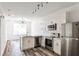 Bright, modern kitchen features stainless steel appliances, white cabinets, and durable countertops at 525 Parkway Dr # 218, Atlanta, GA 30354