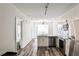 Modern kitchen with stainless steel appliances, white cabinetry, and a stylish chandelier over the central island at 525 Parkway Dr # 218, Atlanta, GA 30354