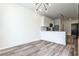Eat-in kitchen featuring stainless steel appliances, white cabinets, and wood-look flooring at 525 Parkway Dr # 218, Atlanta, GA 30354