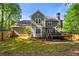 The backyard has a wooden deck with stairs down to a landscaped space surrounded by a wooden fence at 5661 Fairwood Nw Dr, Acworth, GA 30101