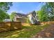 The backyard is a large green space surrounded by a wooden fence with a house and deck at 5661 Fairwood Nw Dr, Acworth, GA 30101